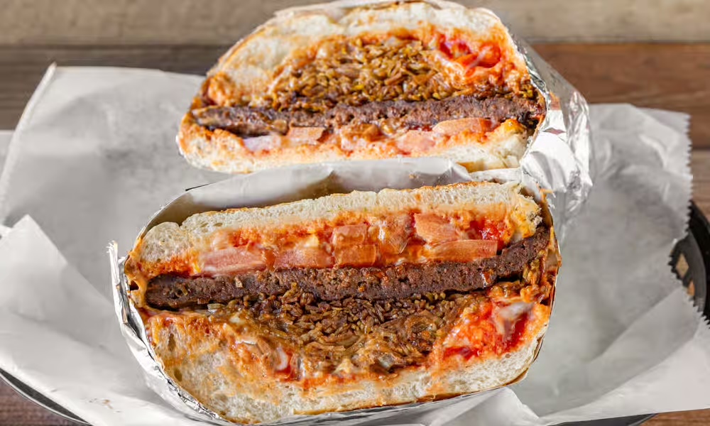 Chimi de Res — Dominican beef sandwich cut in half